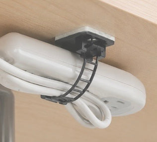 Pack of 25 Problems Solved 3M self-adhesive cable organizers for desk, shown attached to a workspace surface.