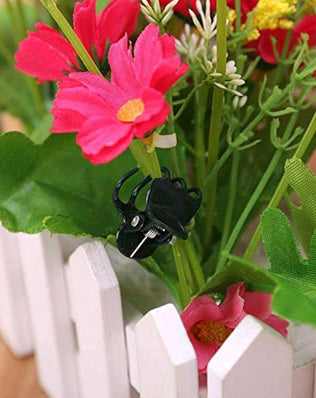 Set of 100 plastic plant support clips from Problems Solved, used for supporting flower and garden stems.