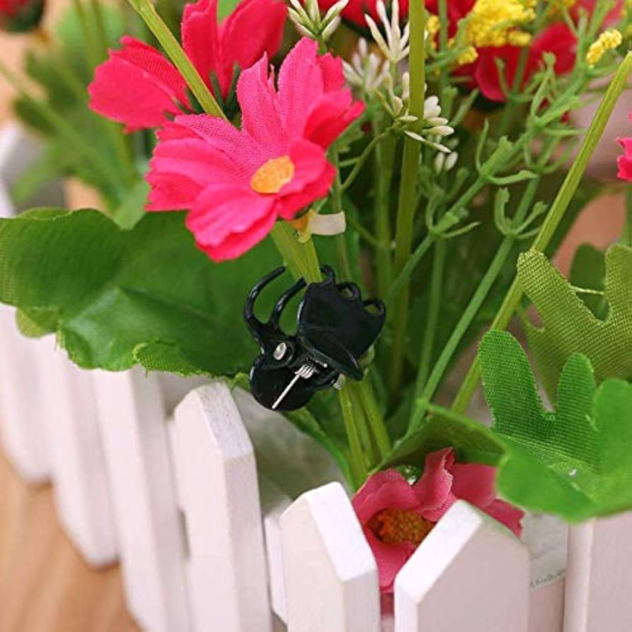 Set of 100 plastic plant support clips from Problems Solved, used for supporting flower and garden stems.