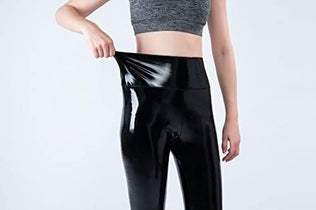 Women mirror faux patent leather leggings by Problems Solved with shiny, reflective stretch fabric, shown on a model.
