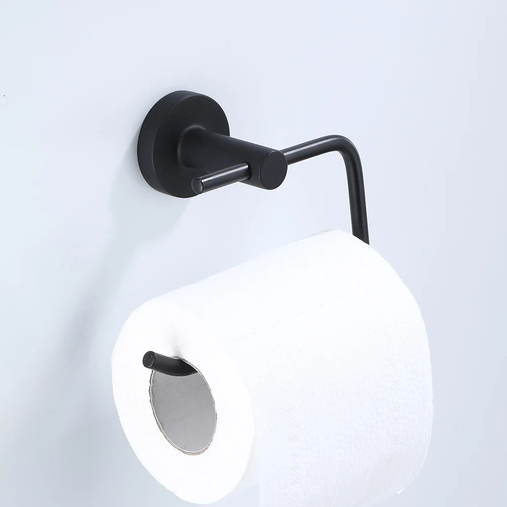 Black bathroom hardware set including robe hook, towel rail, bar rack, shelf, and tissue paper holder by Problems Solved