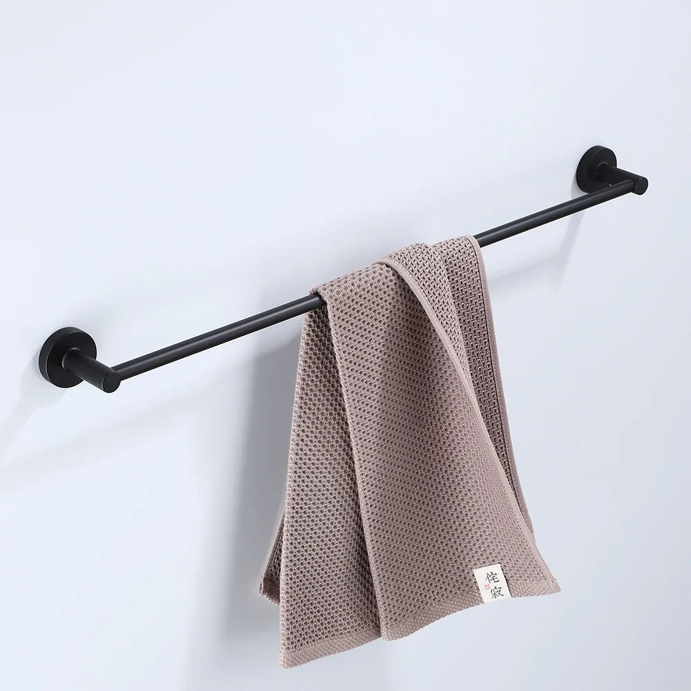 Black bathroom hardware set including robe hook, towel rail, bar rack, shelf, and tissue paper holder by Problems Solved