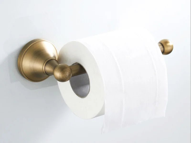Antique brass wall-mounted toilet paper holder from Problems Solved, designed for bathroom accessories with elegant vintage style.