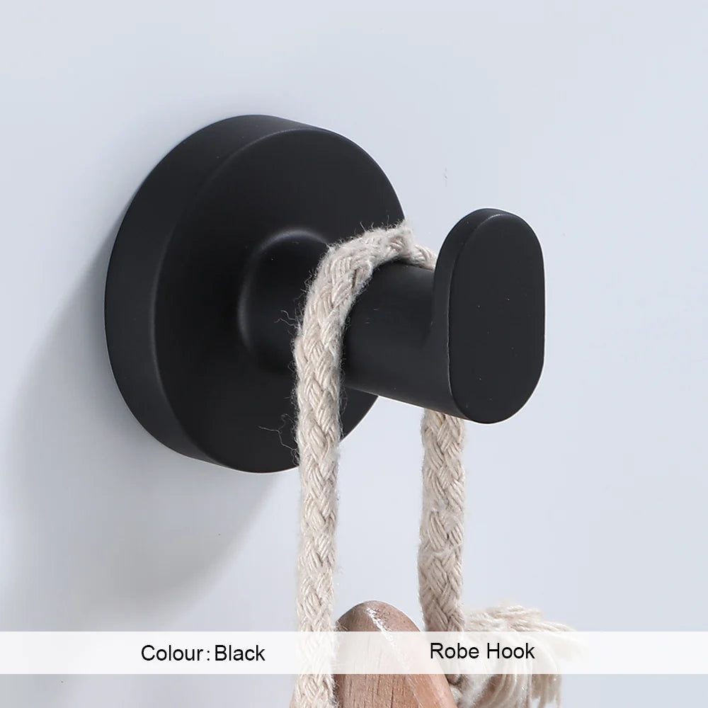 Black bathroom hardware set including robe hook, towel rail, bar rack, shelf, and tissue paper holder by Problems Solved