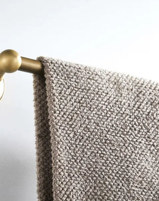 Antique brass wall-mounted toilet paper holder with a classic design, suitable for bathroom accessories by Problems Solved.