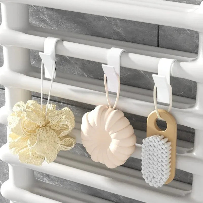 Problems Solved heated bathroom shower towel holder radiator rail with sleek design, mounted on a tiled wall.