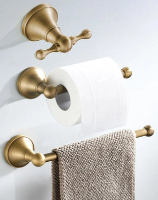 Antique brass wall-mounted toilet paper holder from Problems Solved, showcasing a vintage-style bathroom accessory with a sturdy mount.