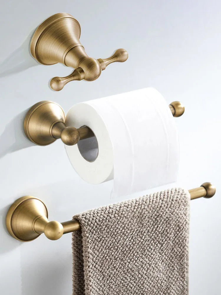 Antique brass wall-mounted toilet paper holder from Problems Solved, showcasing a vintage-style bathroom accessory with a sturdy mount.