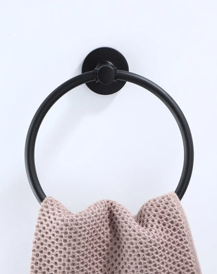 Black bathroom hardware set with robe hook, towel rail, bar rack, shelf, and tissue paper holder by Problems Solved