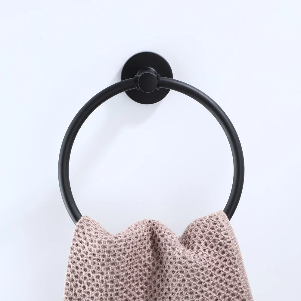 Black bathroom hardware set with robe hook, towel rail, bar rack, shelf, and tissue paper holder by Problems Solved