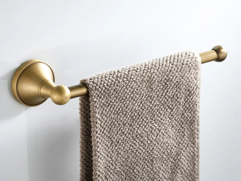 Antique brass wall-mounted toilet paper holder from Problems Solved, with a classic design and sturdy mounting for bathroom decor.