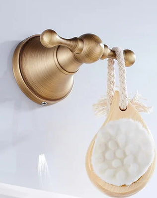 Antique brass wall-mounted toilet paper holder with a vintage design, suitable for bathroom accessories by Problems Solved.