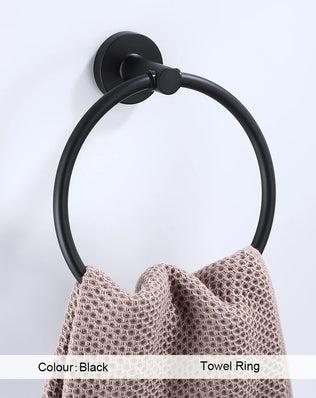 Black bathroom hardware set including robe hook, towel rail, bar rack, shelf, and tissue paper holder by Problems Solved.