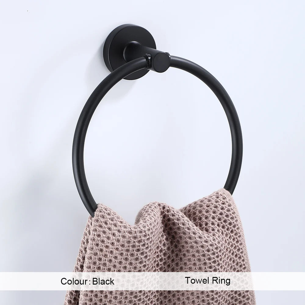 Black bathroom hardware set including robe hook, towel rail, bar rack, shelf, and tissue paper holder by Problems Solved.