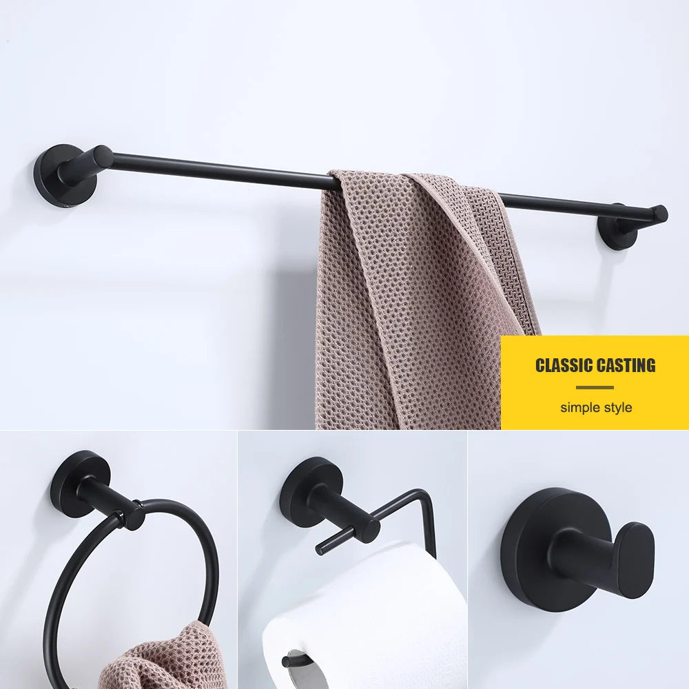 Black bathroom hardware set including robe hook, towel rail, bar rack, shelf, and tissue paper holder by Problems Solved