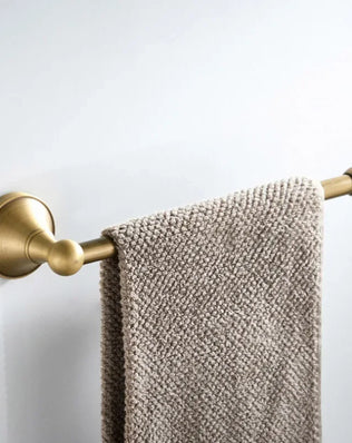 Antique brass wall-mounted toilet paper holder from Problems Solved, featuring a classic design and sturdy mounting for bathroom decor.
