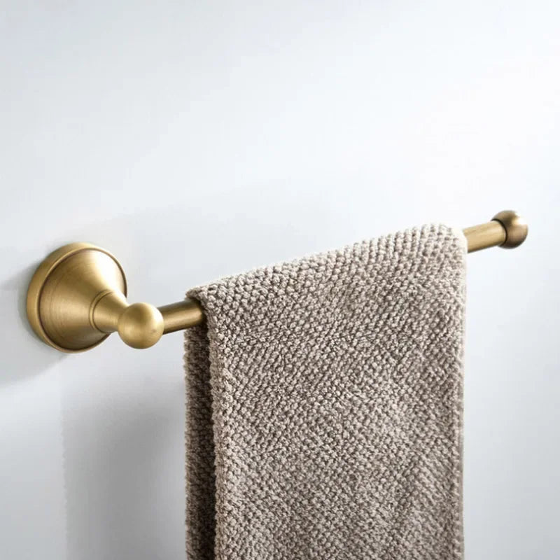 Antique brass wall-mounted toilet paper holder from Problems Solved, featuring a classic design and sturdy mounting for bathroom decor.